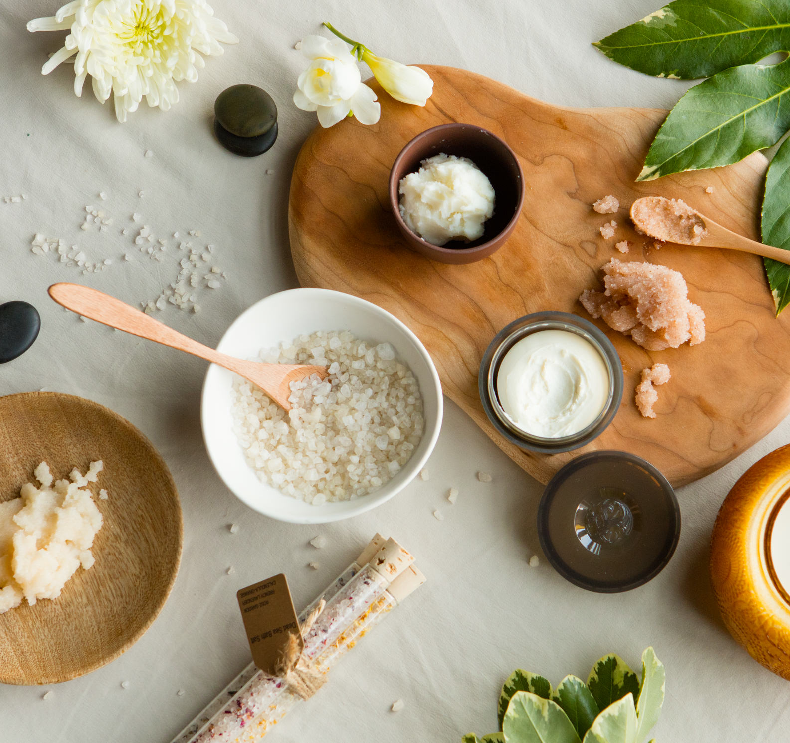 Bath salt, body scrub, and lotion on a table