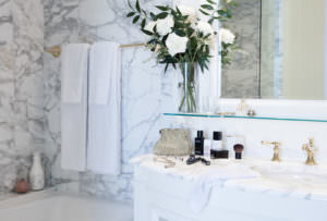 Grand America Hotel Italian marble washroom with separate shower and soaking tub.
