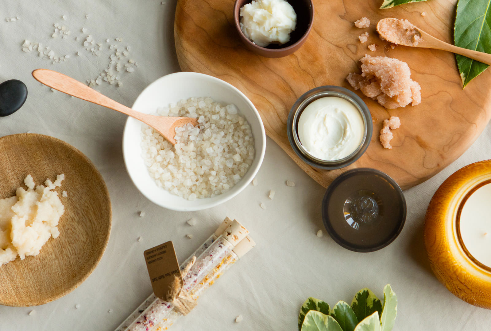 Bath salt, body scrub, and lotion on a table from the Grand Spa