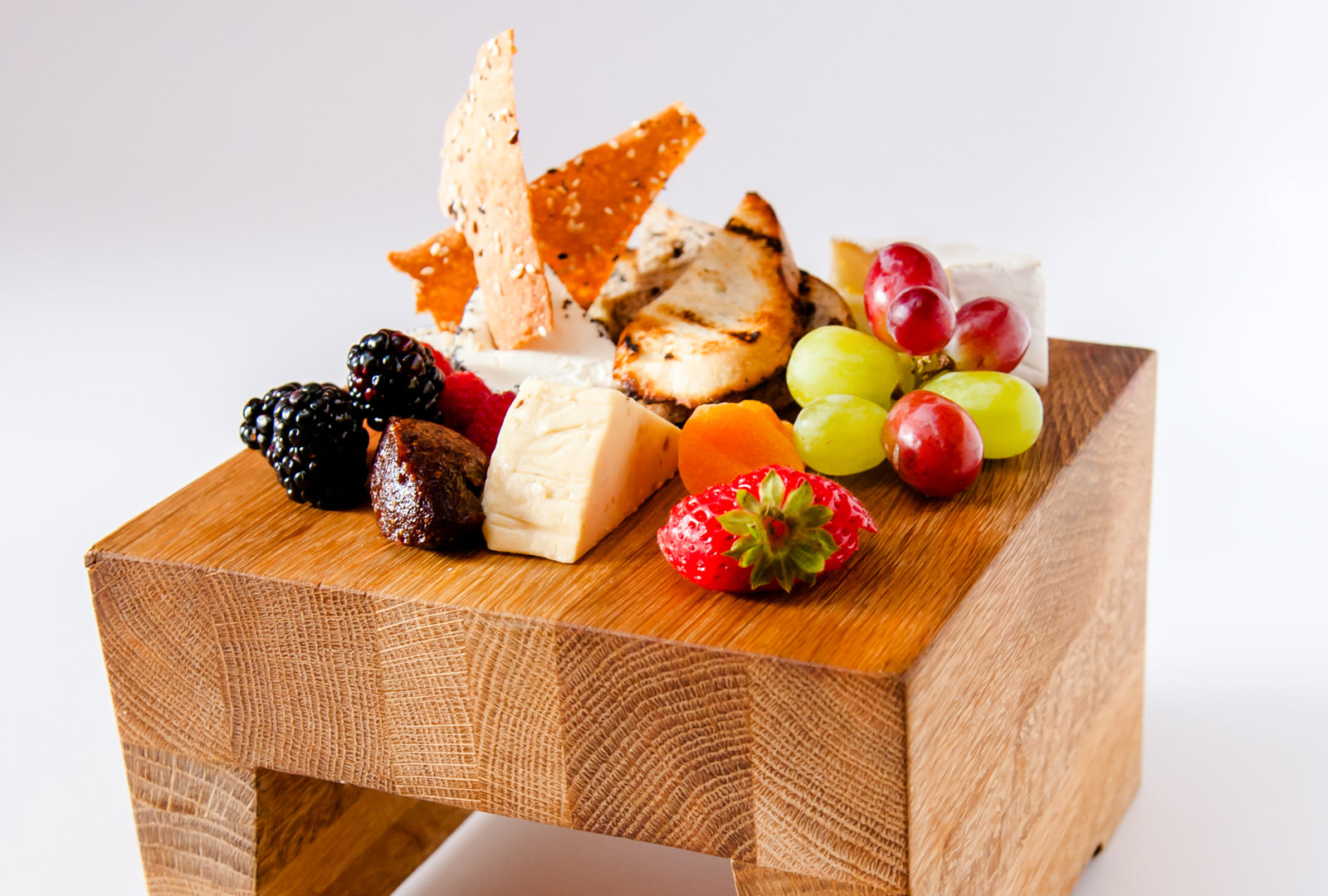 Artisanal Cheeses Platter Containing Local and International Cheeses Along With Fresh Fruit