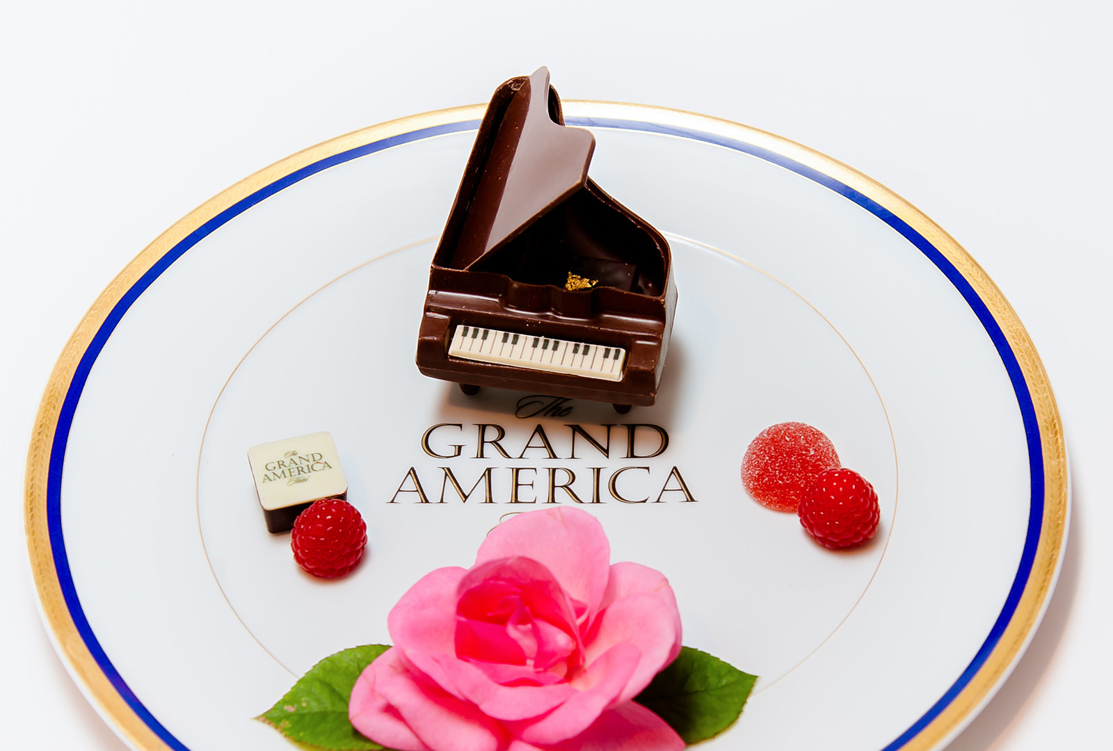 The Grand America Hotel Dark Chocolate Grand Piano With Seasonal Berries and a Fresh Cut Rose