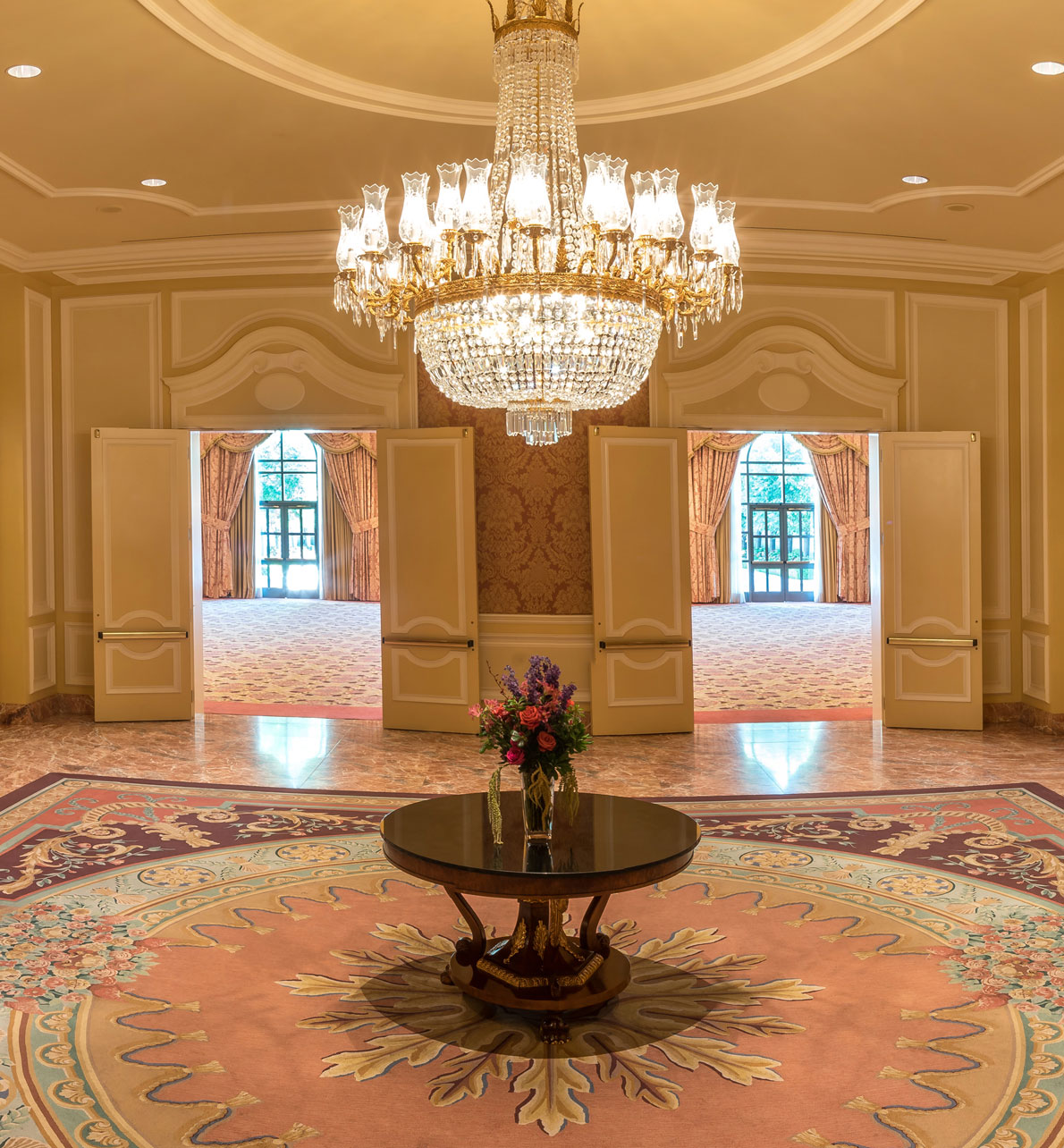 Grand Salon Reception area at the Grand America Hotel featuring pink marble and glass chandeliers.