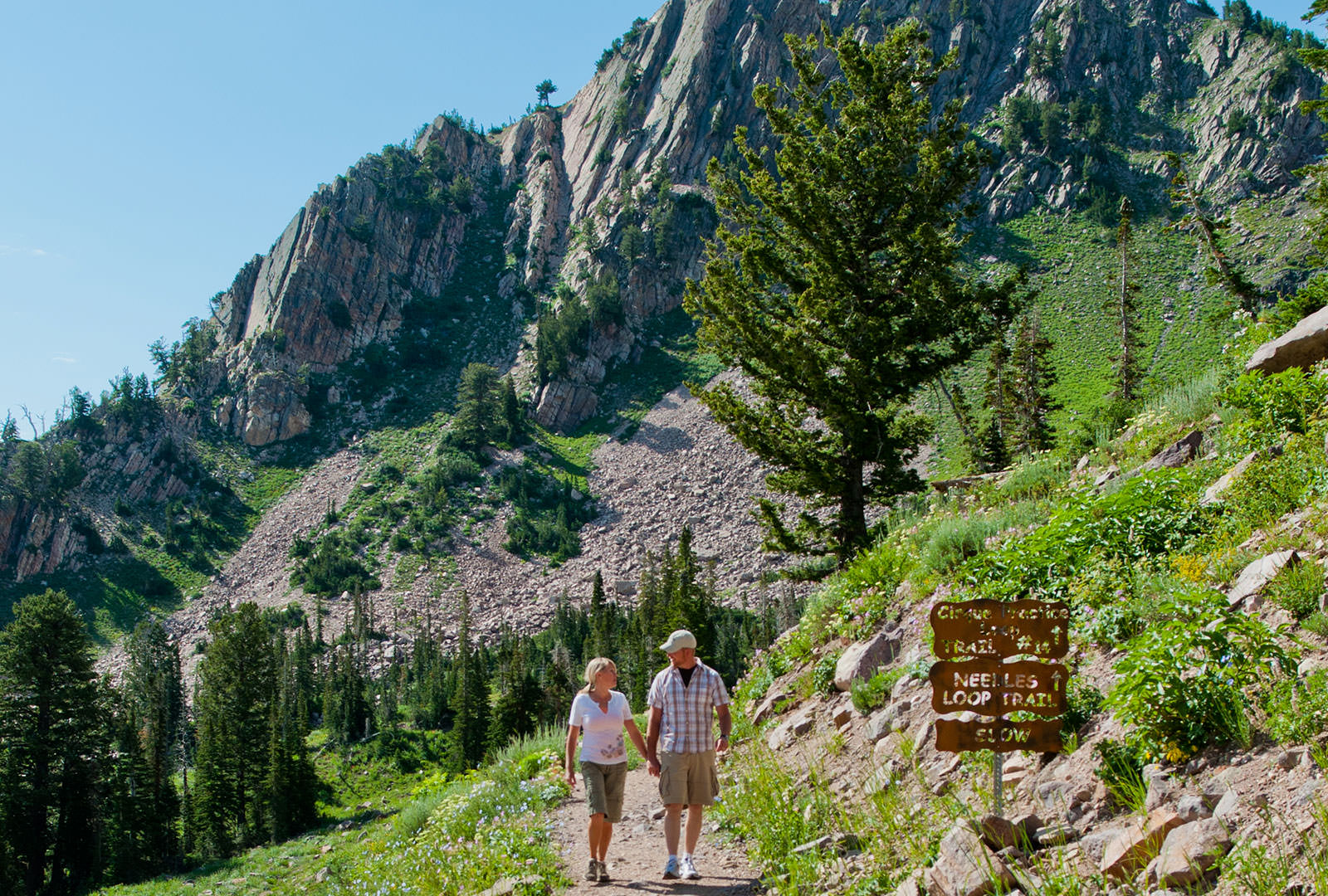 Man and woman hiking in the mountains at Snowbasin
