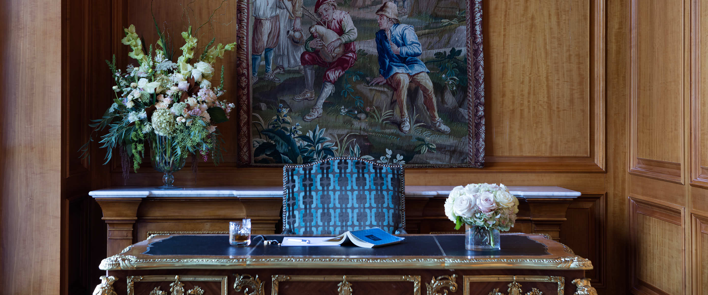 Antique French desk with bronze ormolu trim and an inset leather top located in the north hallway of The Grand America Hotel.