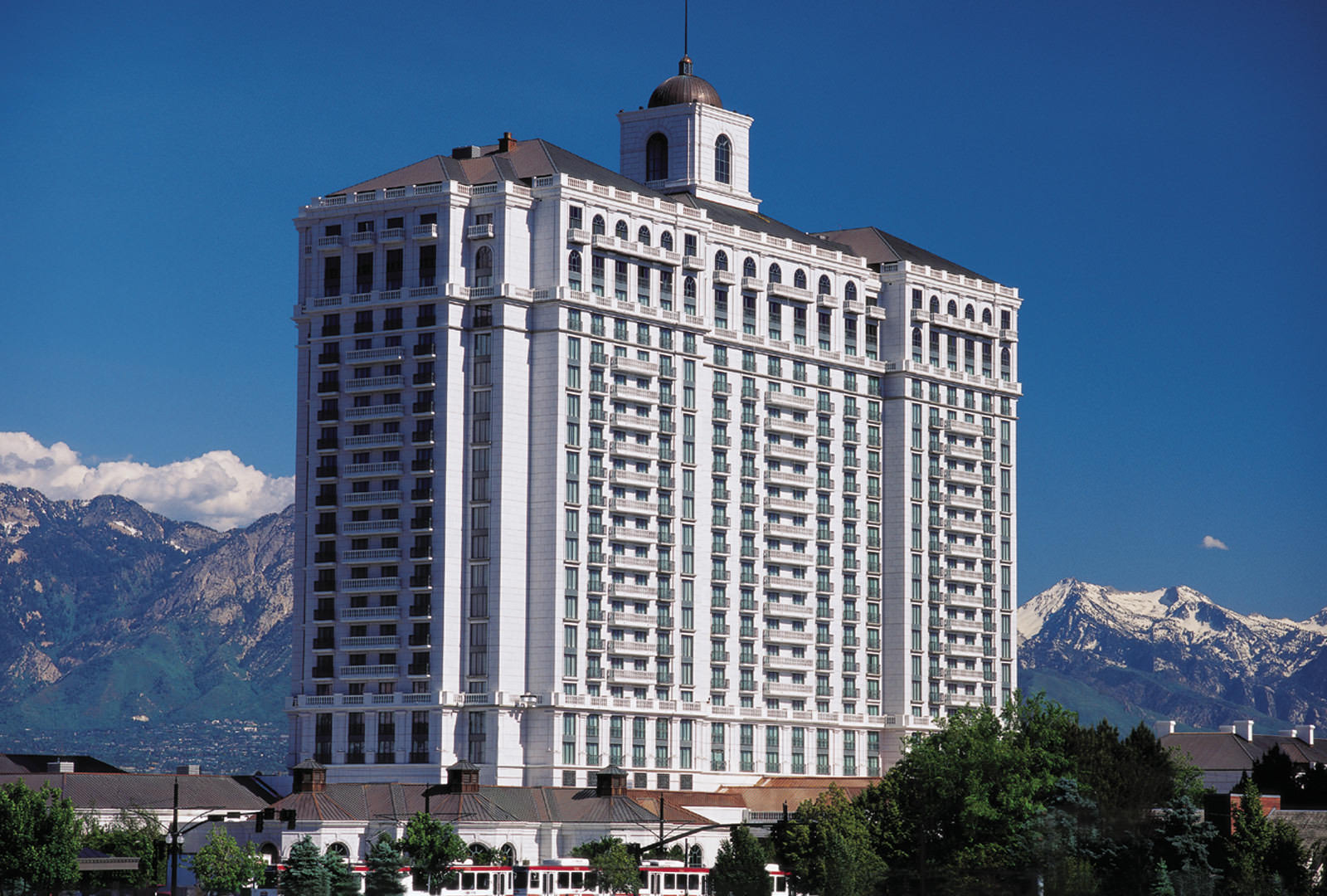 Grand America Hotel white granite exterior with mountains in the background