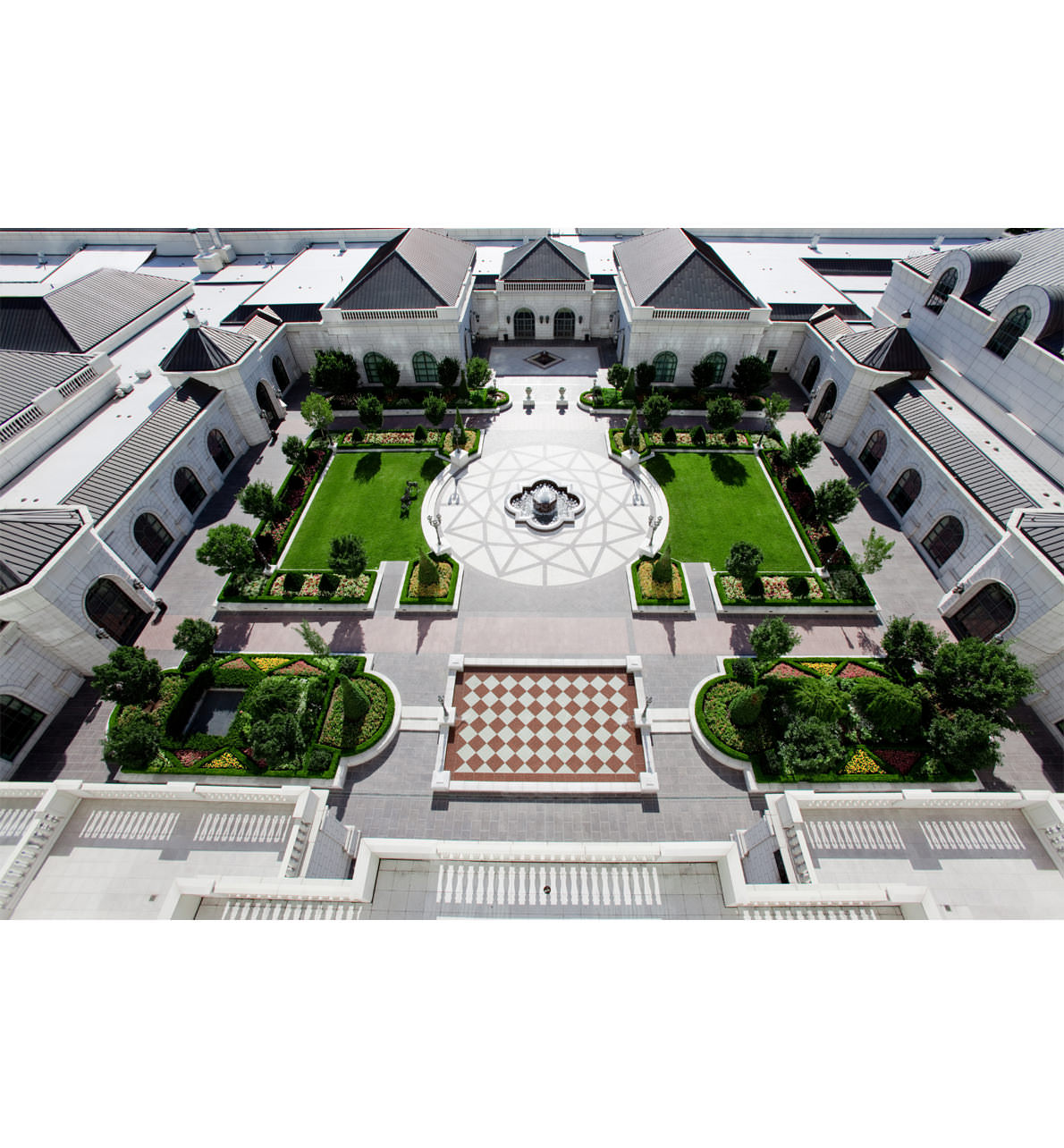 Aerial view of the Garden Courtyard at The Grand America Hotel, featuring green manicured lawns, flower beds and reception space