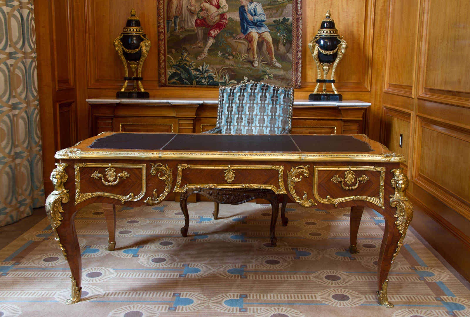 The Grand America Hotel's antique French desk with bronze trim and leather top