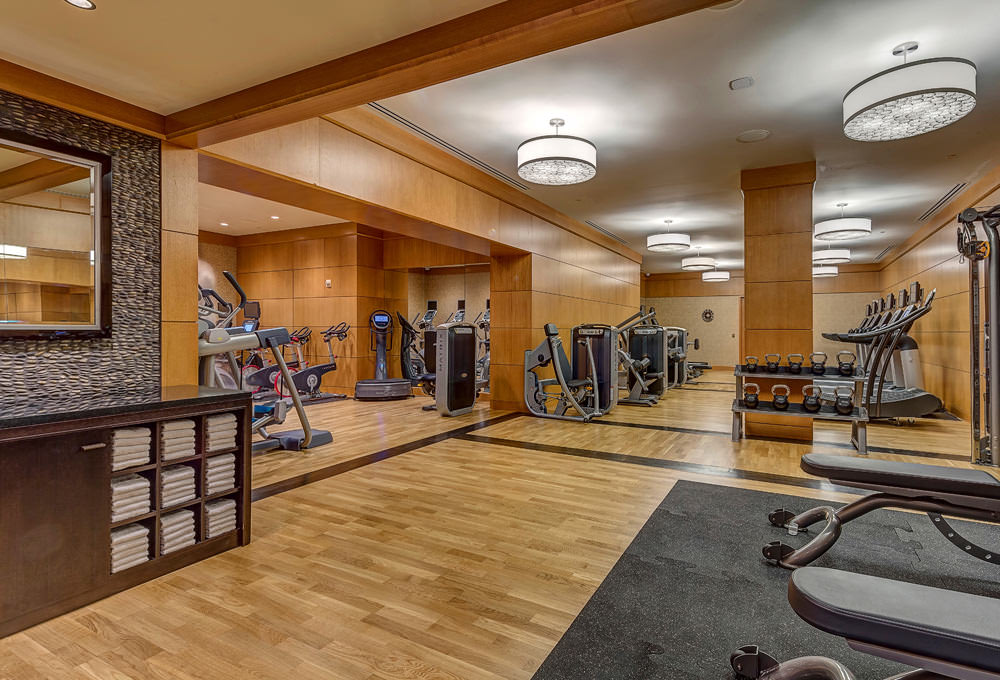 The Grand America fitness center with treadmills, strength training station, and free weights.