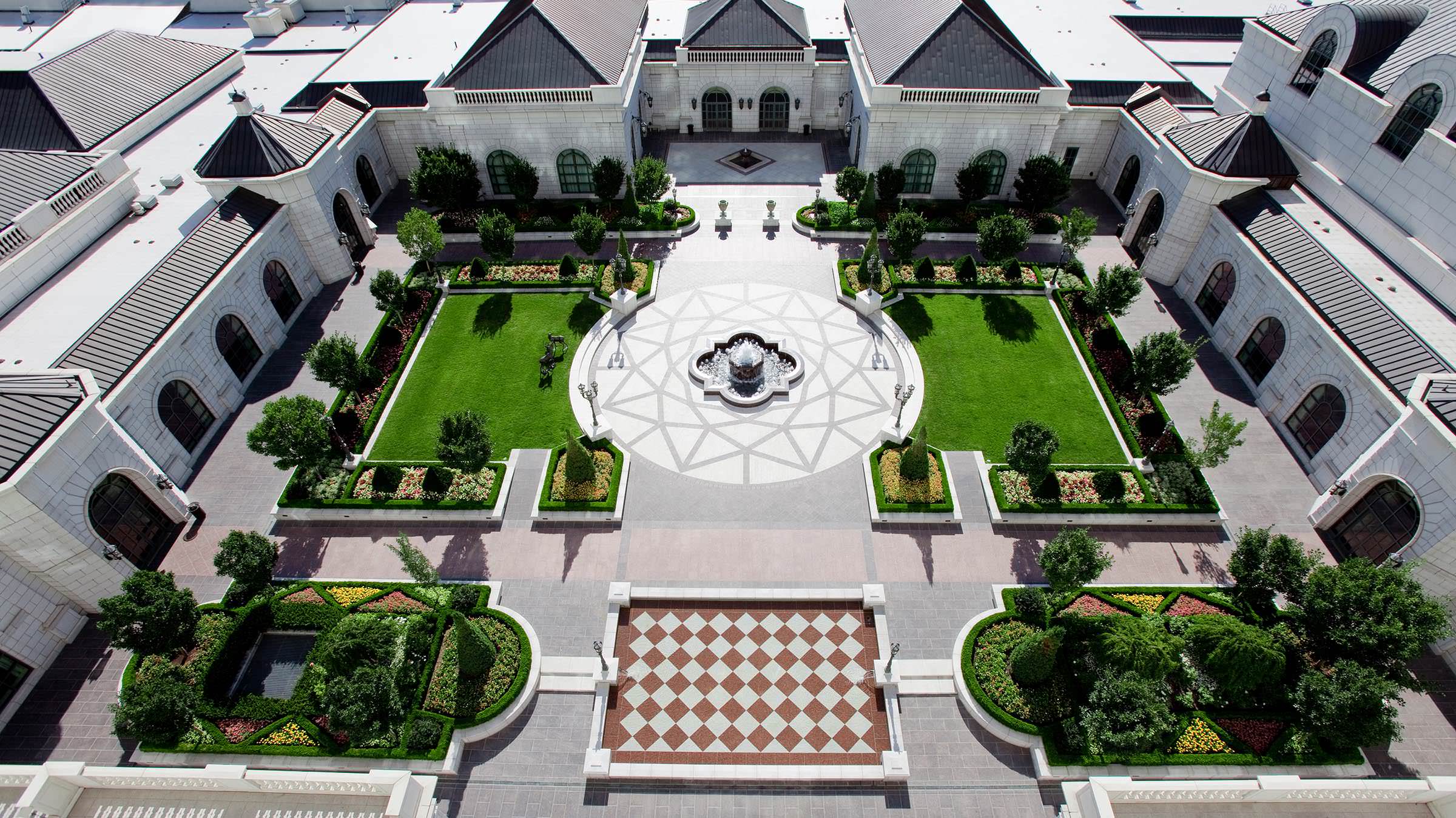 Grand America Hotel's Center Courtyard with green manicured lawns and fountain.