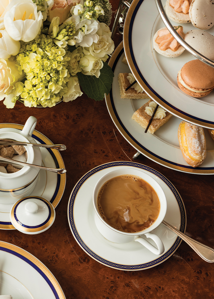 Table with a bowl of sugar cubes, a cup of tea, finger sandwiches, and scones for Afternoon Tea at The Grand America in Salt Lake City.
