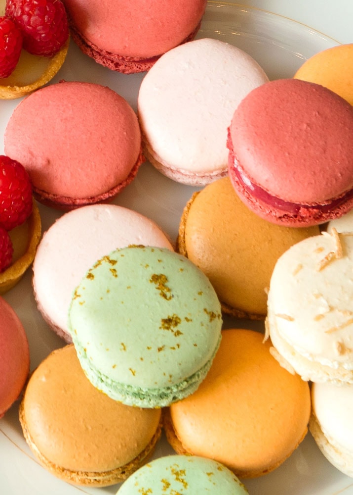 Colorful macarons on a white plate from La Bonne Vie at The Grand America.