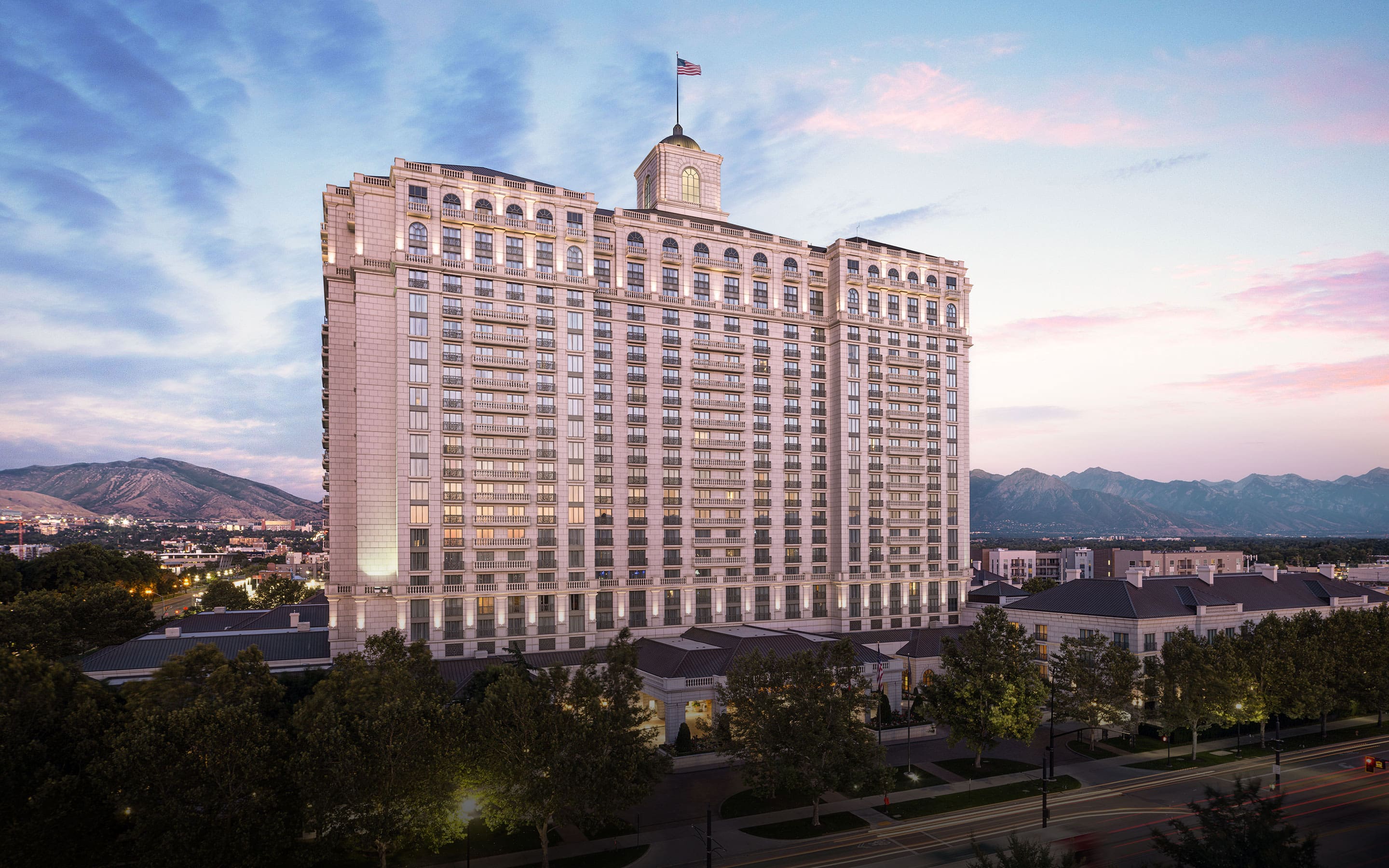 Exterior view of the west side of The Grand America Hotel at sunset.