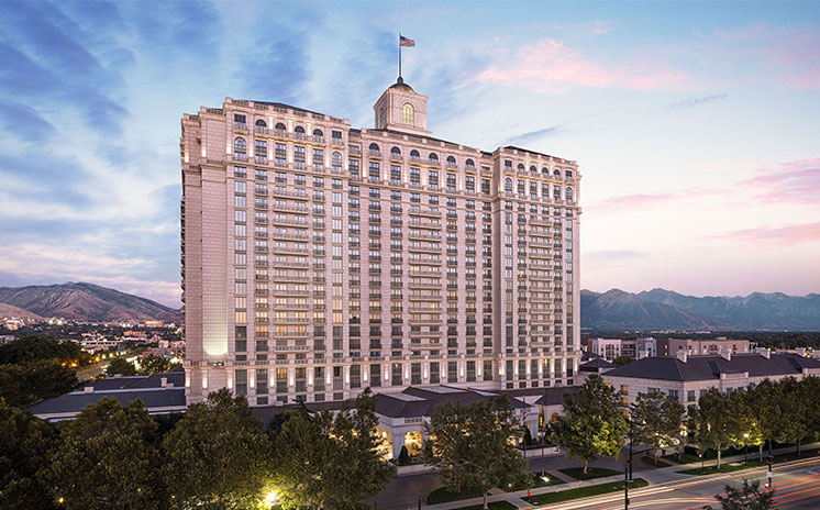 Exterior view of the west side of The Grand America Hotel at sunset.