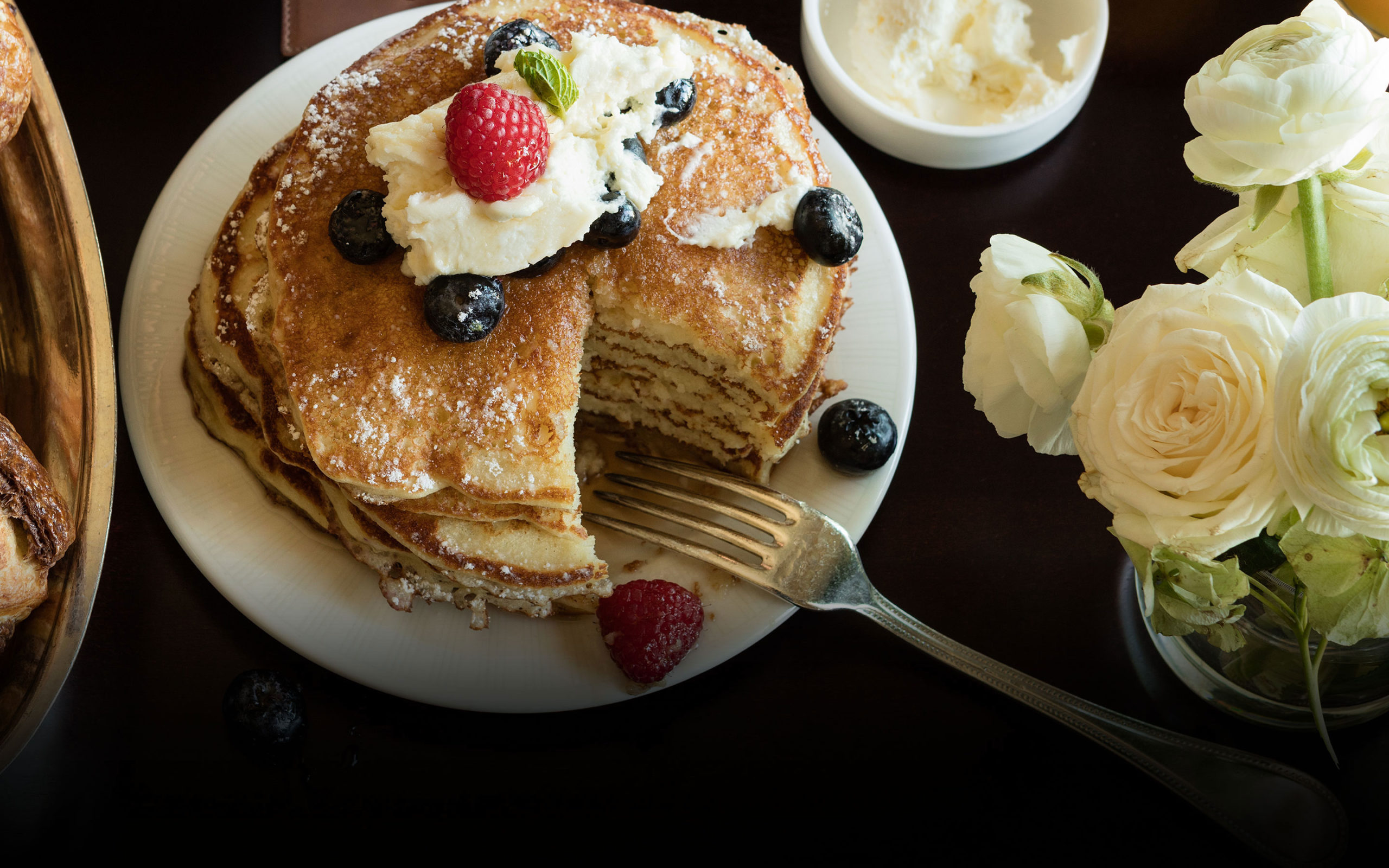 Stack of Pancakes with berries and whipped cream
