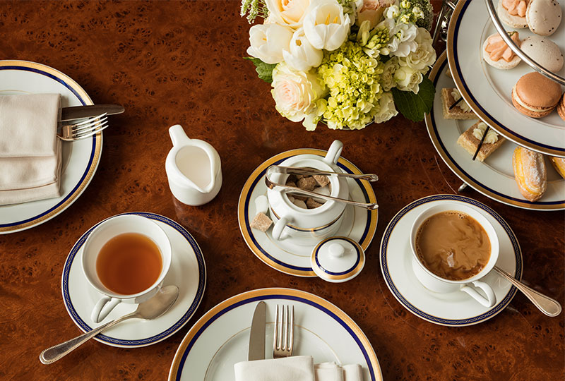 Table with a bowl of sugar cubes, a cup of tea, finger sandwiches, and scones for Afternoon Tea at The Grand America in Salt Lake City.