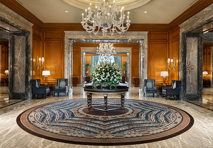 Hotel Lobby with Floral Arrangement and Large Chandelier