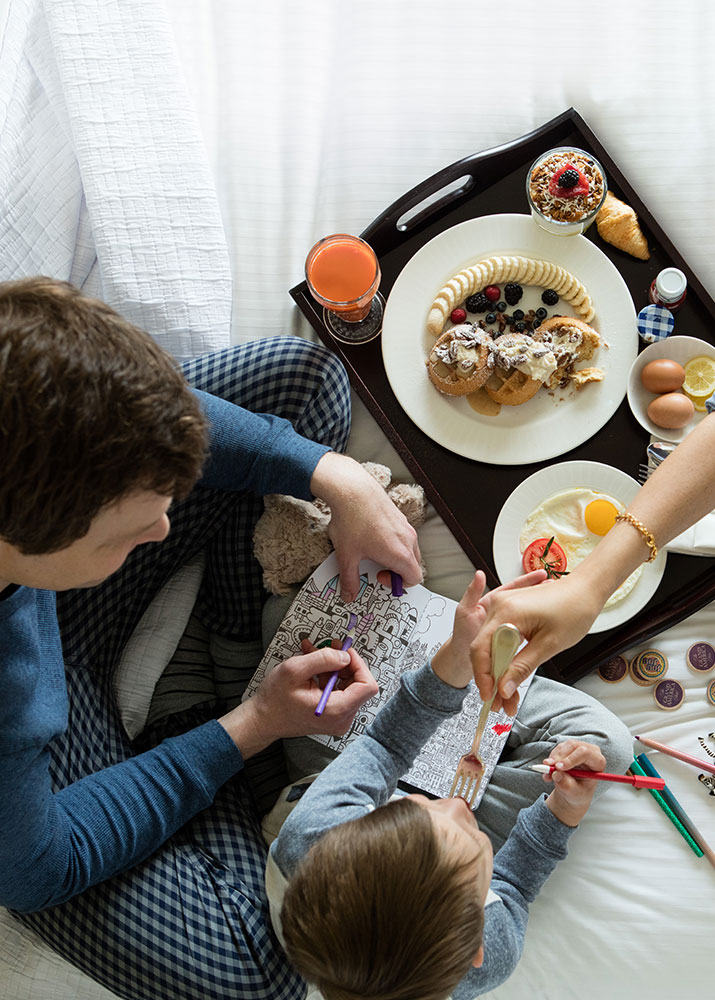 Father and Son eating breakfast in bed