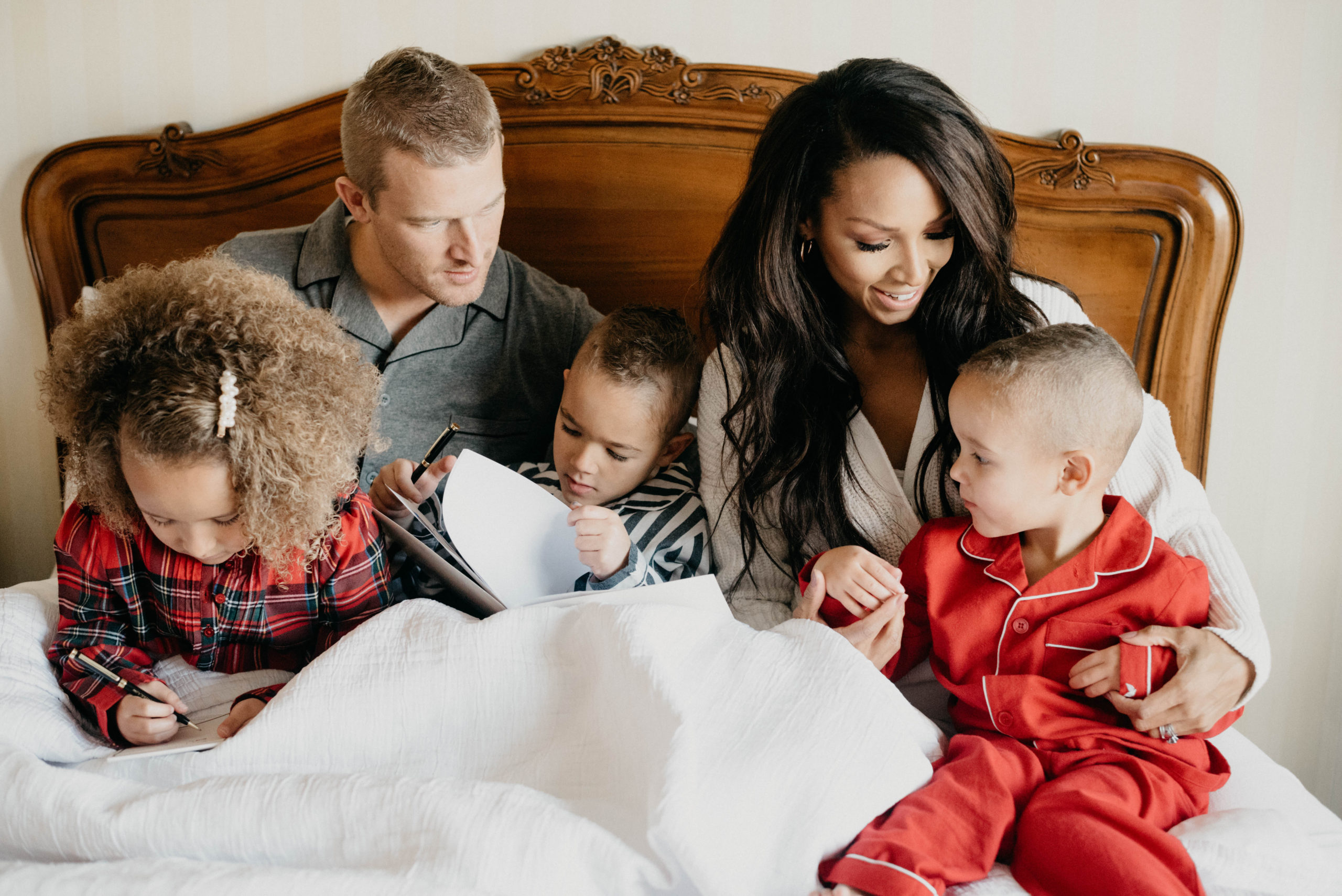 Family sitting in bed at the Grand America Hotel in Salt Lake City, Utah.