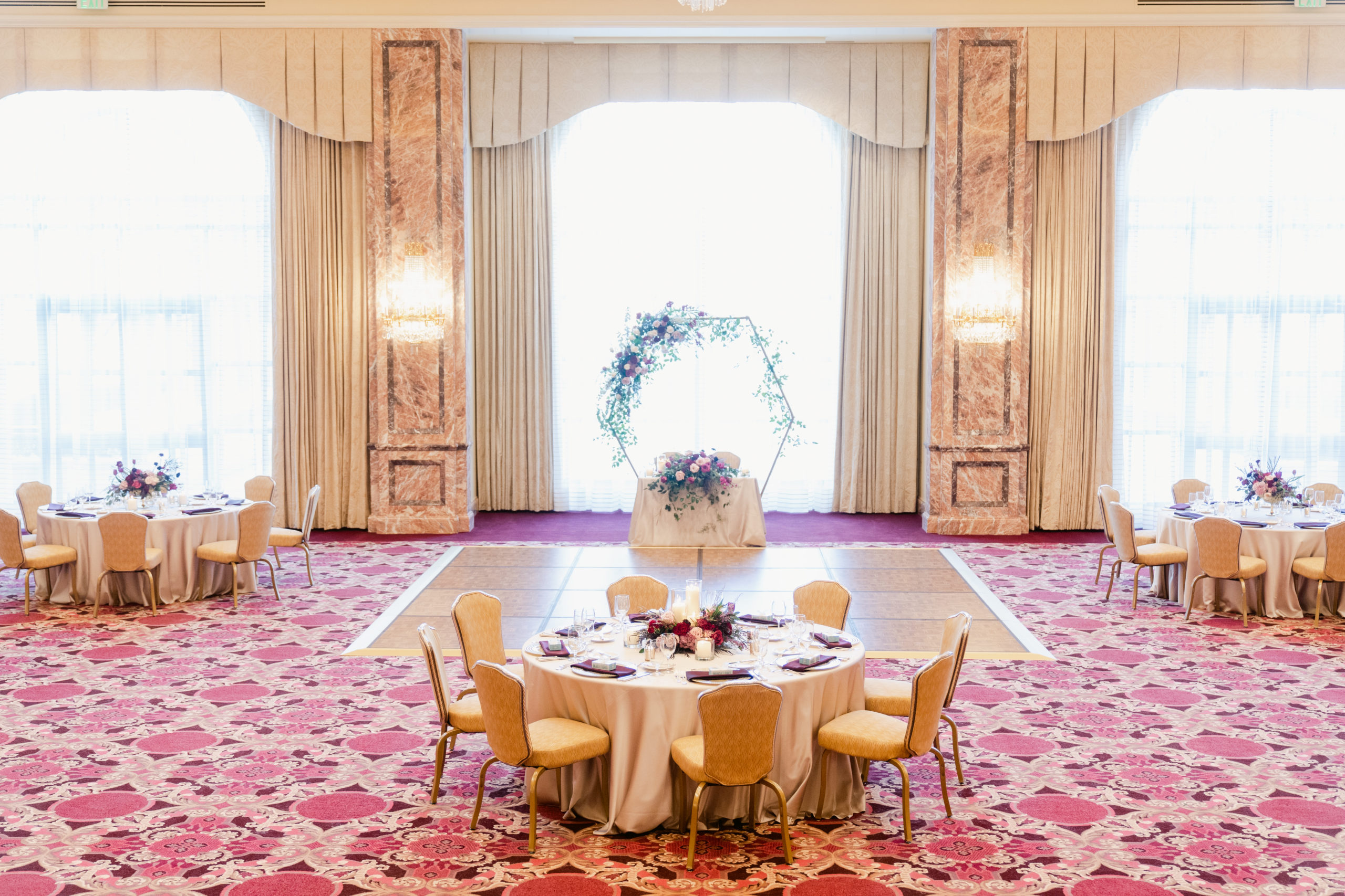 Wedding Reception set up of a table with chairs, a dance floor, and the Sweetheart's Table in The Grand Salon at The Grand America Hotel.
